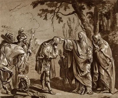 A man wearing a cloak touching the head of a bowing man, during an outdoor ceremony