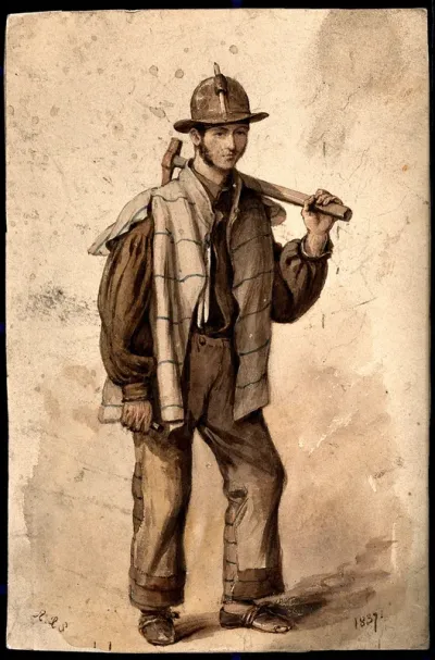 A man wearing a helmet is carrying a long-handled hammer on his shoulder