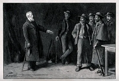 A man wearing a long coat and carrying hat and walking stick is pointing towards a group of less well-dressed men