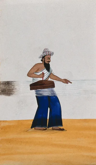A man with a long beard and a checked cap carding thread