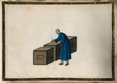 A man writes on sealed crates of tea, ready for export