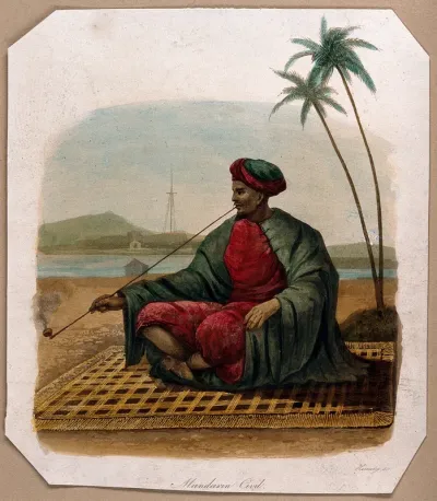 A Mandarin sits on a mat, smoking a long opium pipe