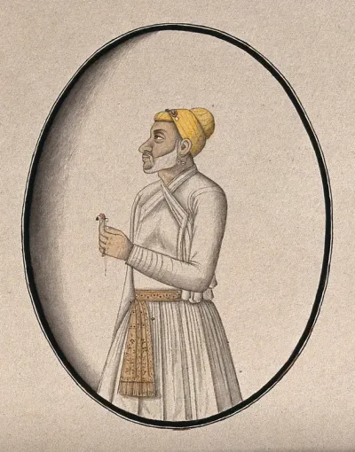 A Mughal courtier with a yellow turban holds an ornament (?)
