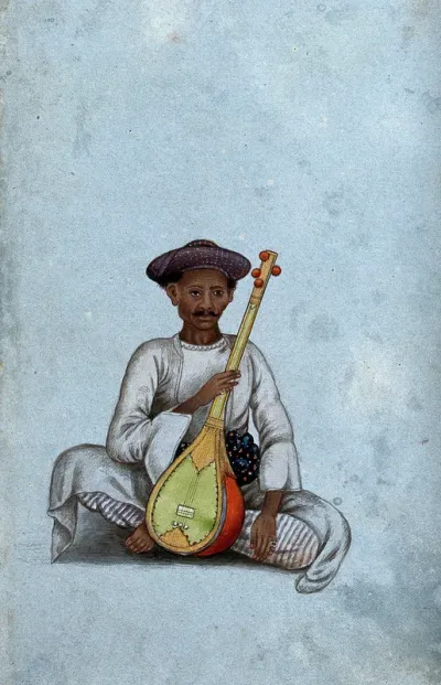 A musician holding a sitar