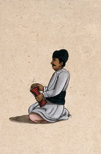 A musician holding an Indian percussion instrument