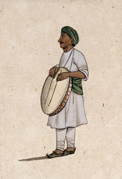A musician playing a daf, an Indian percussion instrument, with sticks