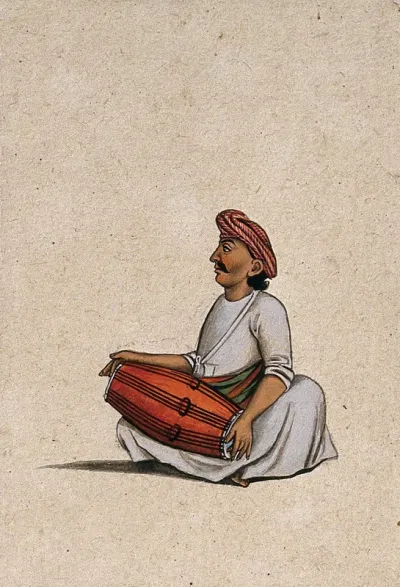A musician playing the dholak (double sided drum)