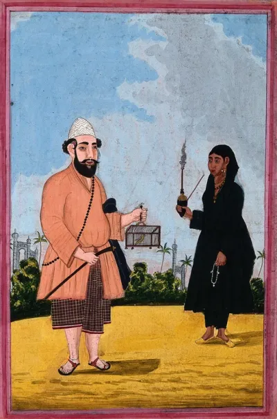 A Muslim man holding a bird in a cage with a women holding a pipe