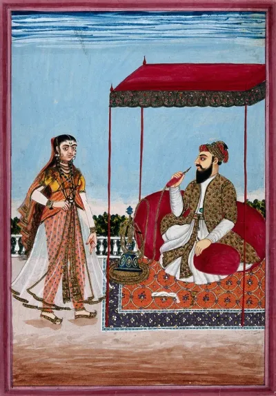 A Muslim man smoking a hookah under a canopy, with a woman on the left