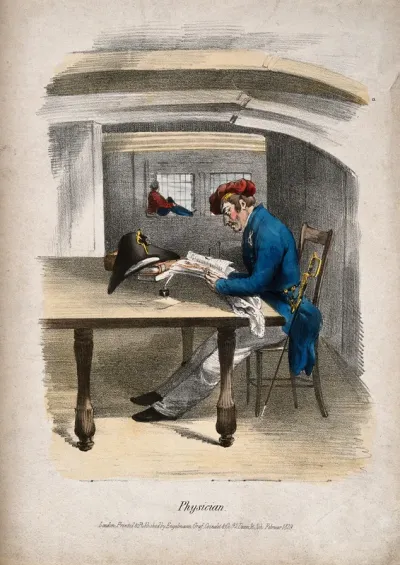 A naval physician in uniform studying books at a large table