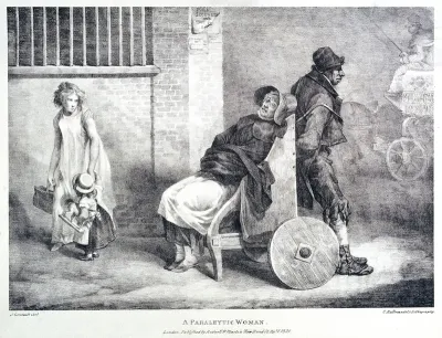 A paralyzed woman being transported along the street in a wheelchair