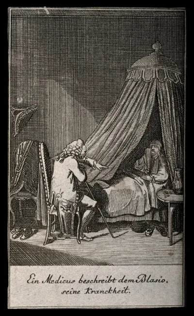 A physician talking to a patient who is in bed