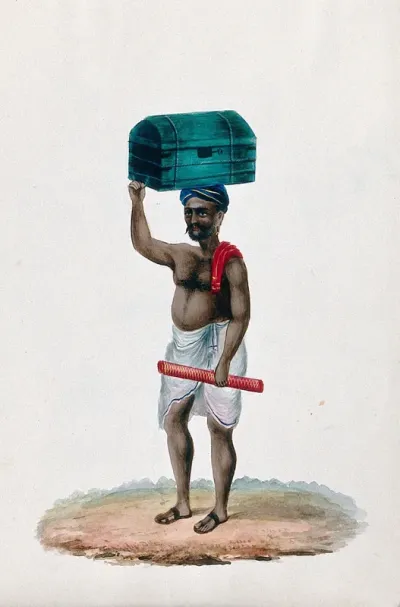 A porter carrying a chest on top of his head