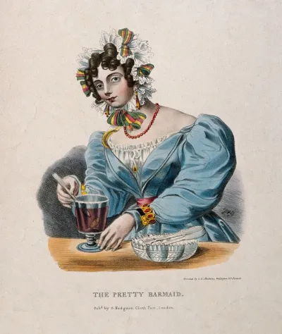 A pretty barmaid mixing a drink in a glass
