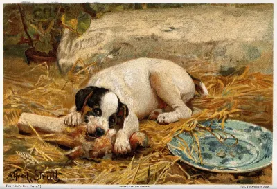 A puppy lying on a straw bed gnawing a bone