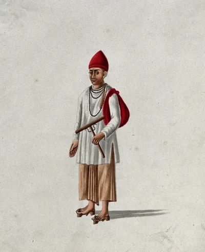 A religious man wearing a red cap and prayer beads around his neck