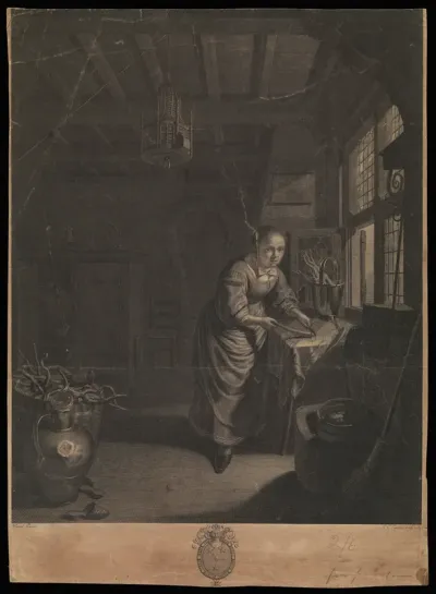 A room in a house in North-Holland, in which a young woman cuts a root vegetable next to the window