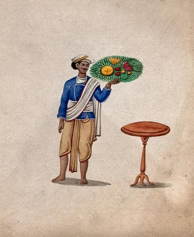 A servant holding up a platter of fruit or vegetables