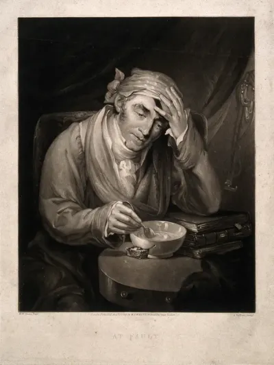 A sick man holding his head, leaning on a pile of books and mixing a dose of medicine for himself
