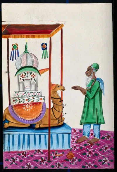A small mosque resting on a camel's back with a man standing before it with folded hands