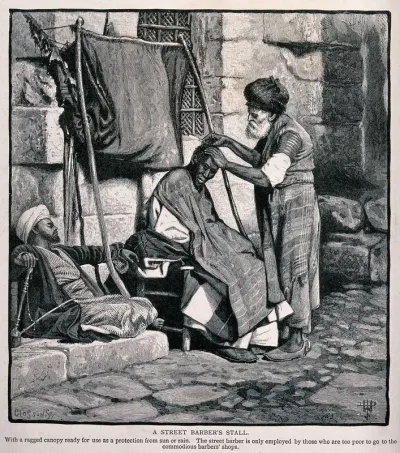 A street barber dressing a man's hair