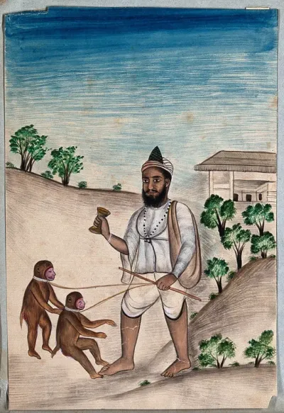 A street entertainer makes two monkeys on a lead, dance to music as part of an act