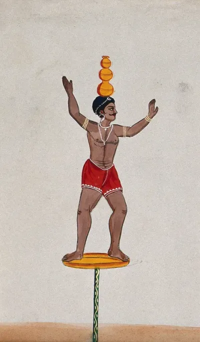 A street performer standing on a disc balancing three pots on his head