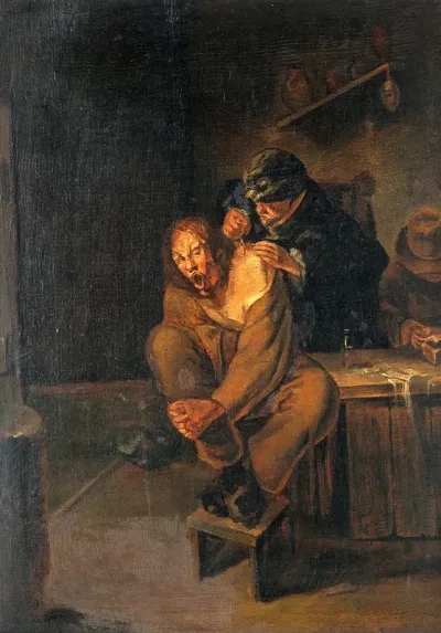 A surgeon operating on a man's shoulder