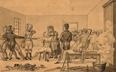 A surgeon supervising two groups of people pulling in opposite directions in order to cure a man with a shoulder dislocation