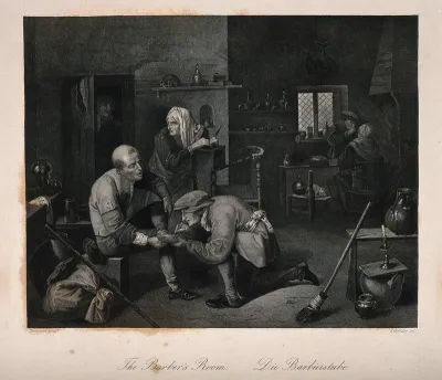 A surgeon treating a patient's foot, in the background another surgeon is examining a patient in a surgery