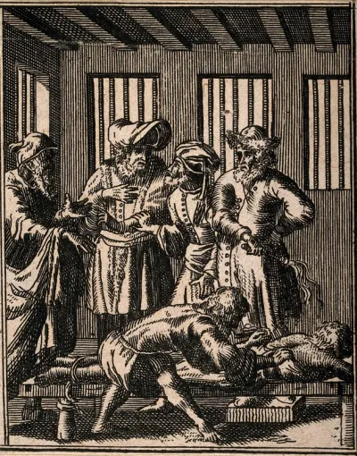 A surgeon treating the back of a man who has been punished by whipping, four men stand over them in a prison cell (?) Etching by J