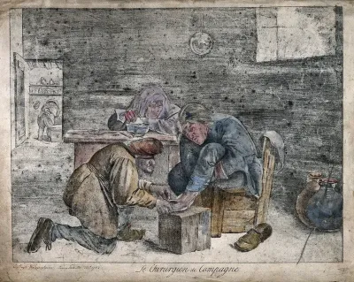 A surgeon treating the foot of a male patient