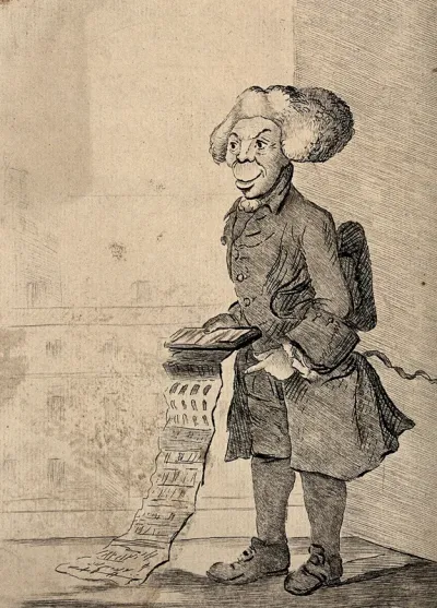 A tailor holding out a folding swatch of cloth samples
