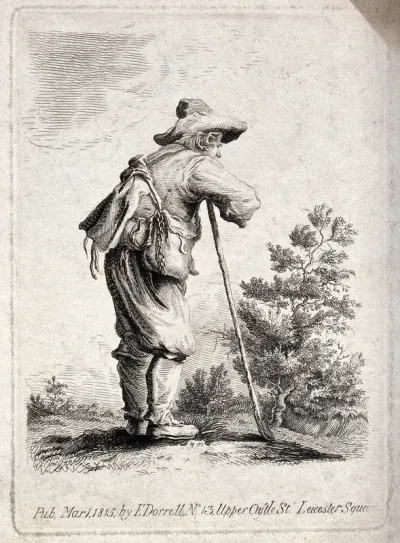 A traveller laden with two bags around his shoulders leans on a stick and overlooks the countryside