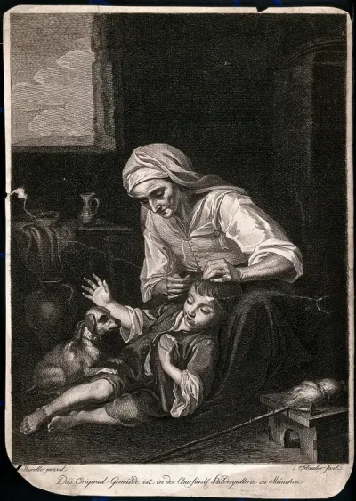 A woman combs a boy's hair while he lies on the floor playing with a dog