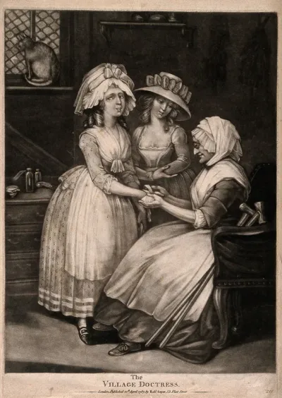 A woman doctor bandaging a young woman's hand