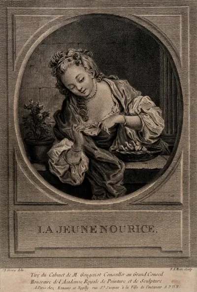 A woman feeding a nest of baby birds