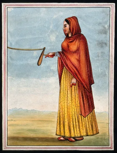 A woman holding a tool to grind (?) which is tied to a rope