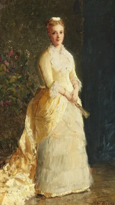 A woman in a long white dress standing in front of flowers.