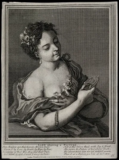 A woman in a shift contemplating a miniature painting of her lover