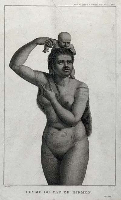 A woman in Cape Van Diemen carrying her baby on her shoulders