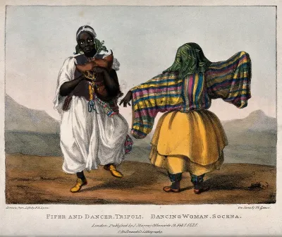 A woman in Libya dancing accompanied by a bagpiper
