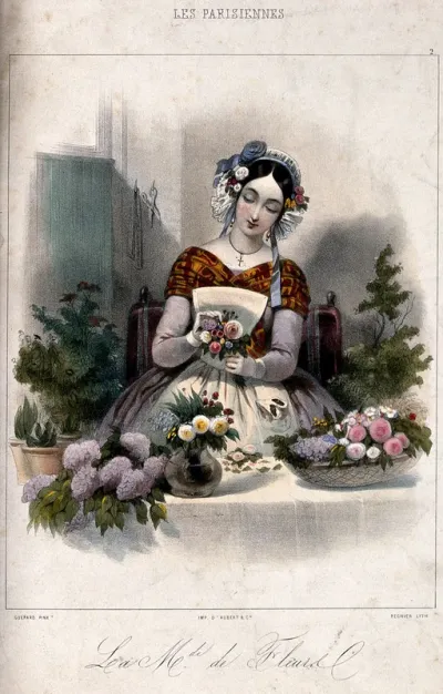 A woman making up posies and baskets of flowers for sale