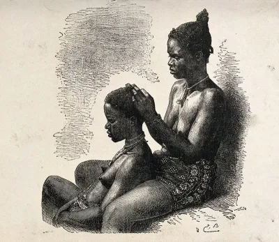 A woman of Grand Bassam, Ivory Coast, dressing another woman's hair