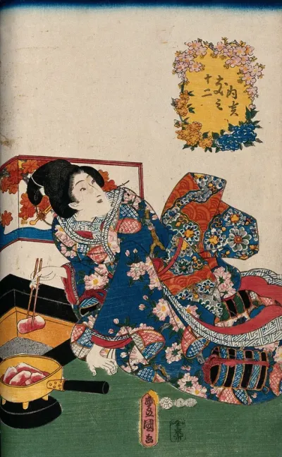A woman placing glowing charcoal in a sand-filled box to provide warmth