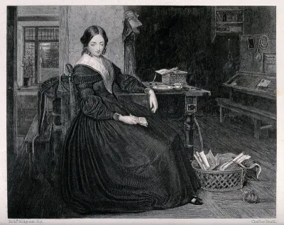 A woman school teacher sits at a table with a book in her hand and a basket of needlework on the floor