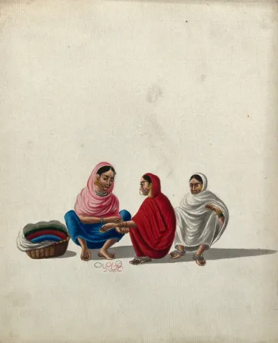 A woman selling bangles, helps a customer to try on some bangles