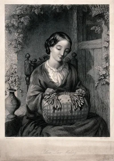 A woman sitting on a chair making lace on a lace-pillow