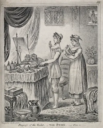 A woman standing at a dressing table while a maidservant laces her stays