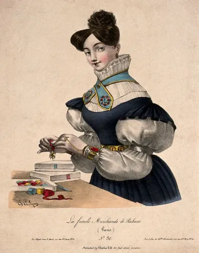 A woman tying ribbon onto a medal